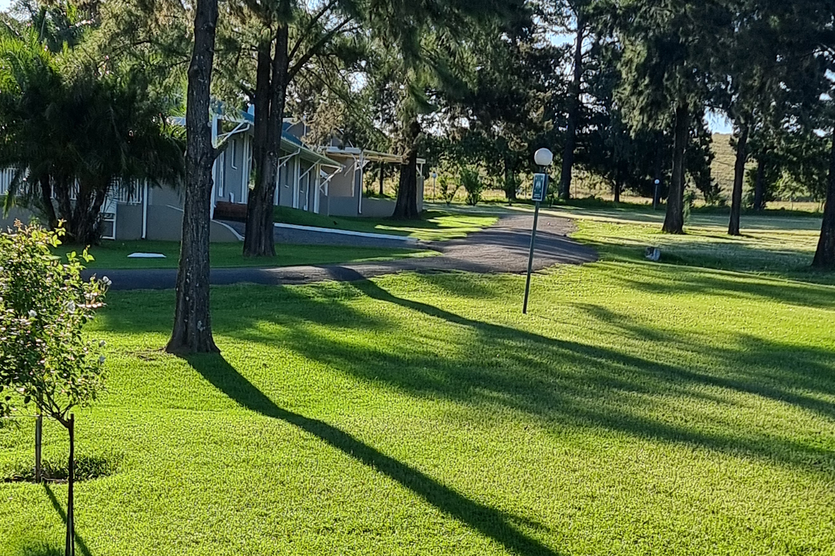 Tree-lined lodge gardens and accommodation buildings